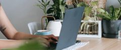 a woman studying results of client surveys on her computer